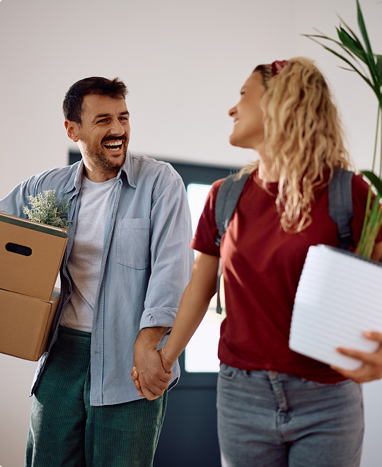 Happy couple moving into a new home, representing homeowners insurance.