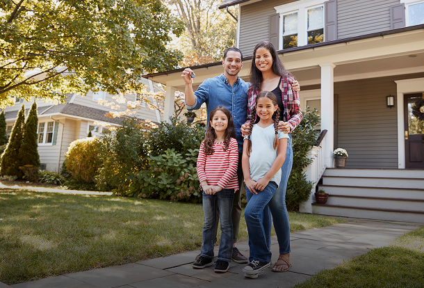 Happy family holding keys to their new home, representing comprehensive homeowners insurance.