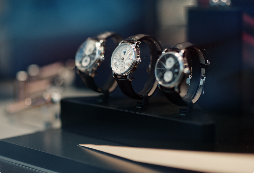 Luxury wrist watches on display in a jewelry store, representing high-value personal property and jewelry insurance.