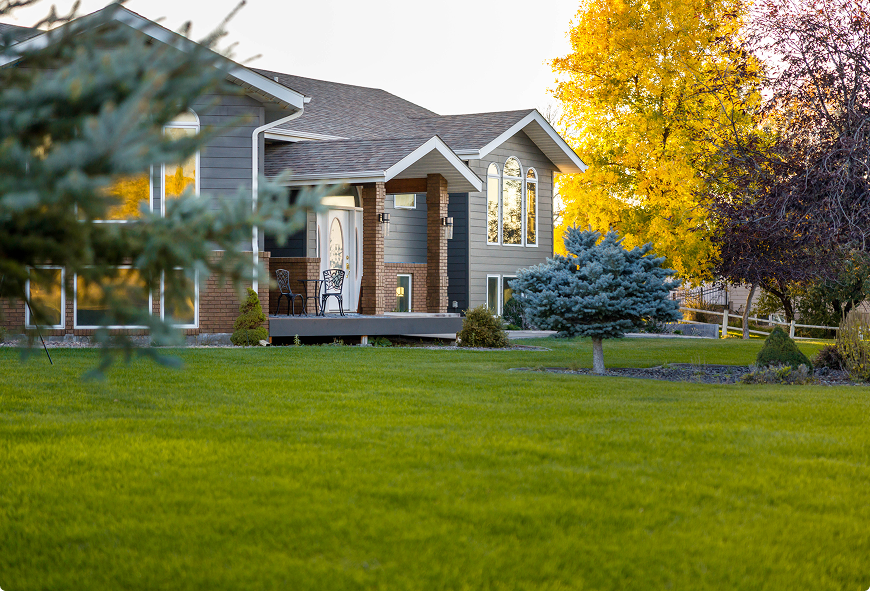 Modern house with a well-manicured green lawn representing Western NY home insurance coverage.