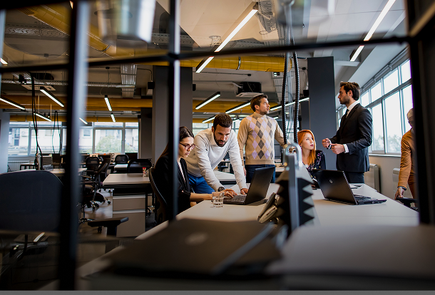 Professional team working in a modern office, collaborating on commercial business insurance planning.